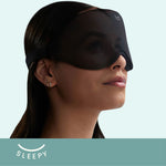Woman wearing Glowco's black Sleepy Sleep Mask, designed for comfortable, deep sleep and total darkness.
