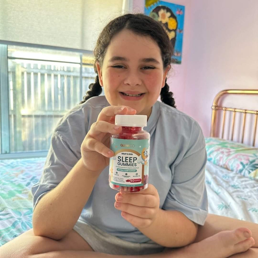 Child holding a bottle of Glowco Sleep Gummies in a bedroom setting