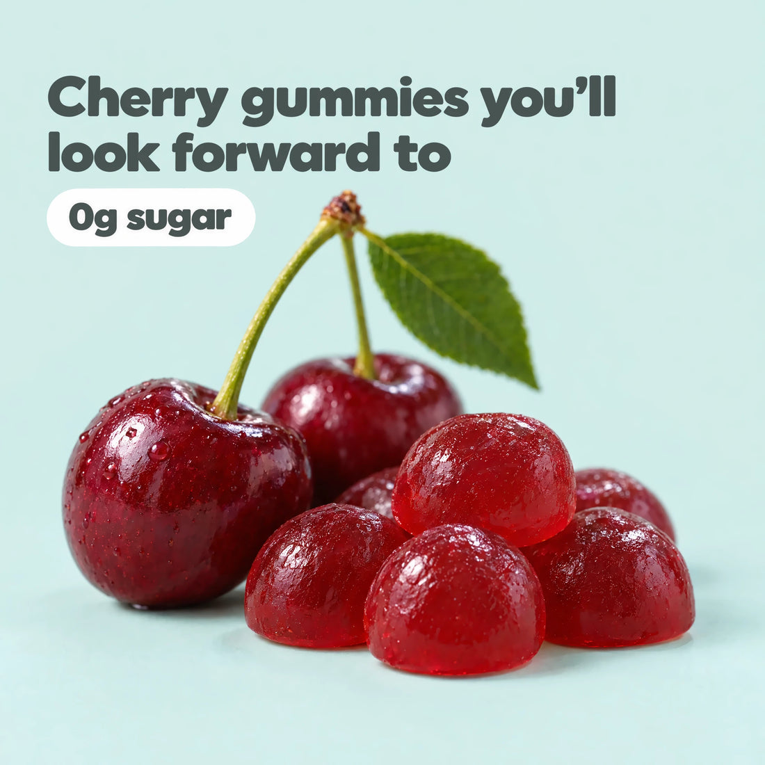 Close-up of cherry adult sleep gummies with fresh cherries, 0g sugar