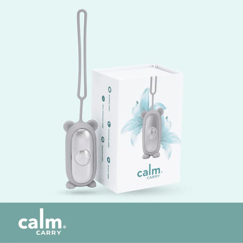 Grey CalmCarry Kids device with its box